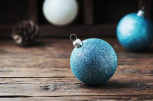 White and blue christmas balls on the wooden table